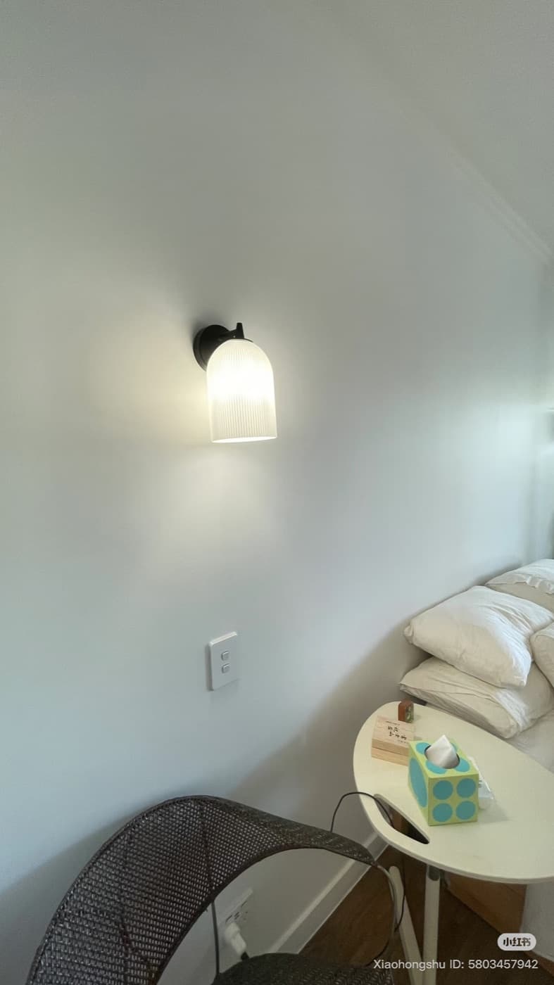 Warm wall light creating soft bedroom lighting